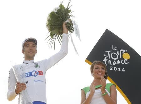 Best young jersey holder FDJ.fr team rider Thibaut Pinot of France celebrates on the podium after the 137.5 km final stage of the 2014 Tour de France, from Evry to Paris Champs Elysees, July 27, 2014. REUTERS/Christian Hartmann