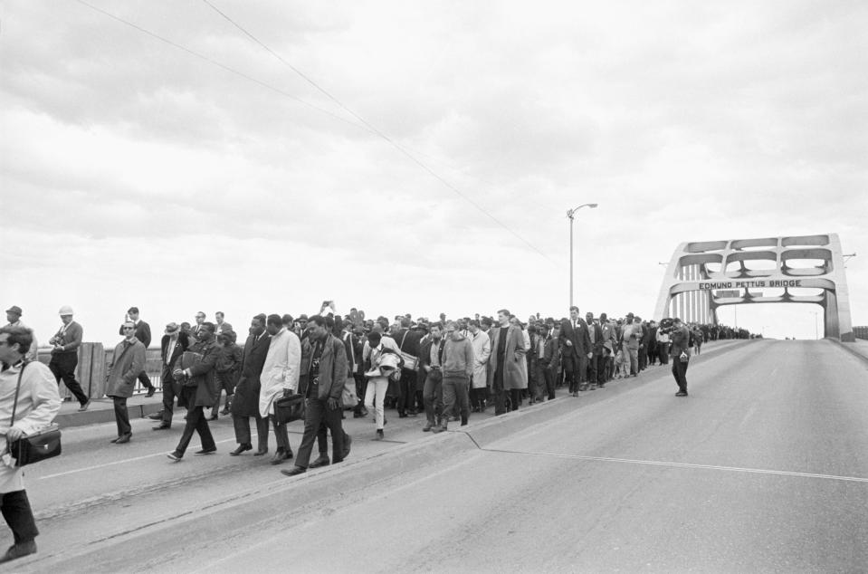 Civil rights marchers led by Martin Luther King, Jr. cross the Edmund Pettus bridge in Selma, Alabama after being turned back by state troopers. The marchers had intended to begin a 50 mile march from Selma to Montgomery to protest race discrimination in