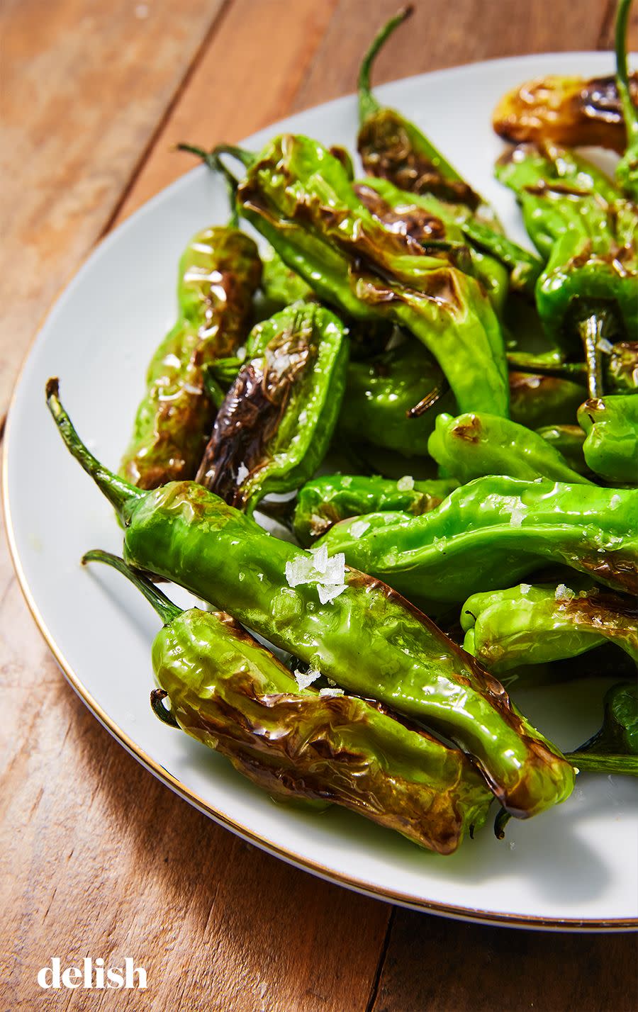 <p>Blistered shishito peppers make for the perfect flavorful, <a href="https://www.delish.com/cooking/nutrition/g600/healthy-snacks-for-work/" rel="nofollow noopener" target="_blank" data-ylk="slk:healthy snack" class="link ">healthy snack</a>. They aren't very spicy (only 1 in 10 gets anywhere near the heat of, say, a jalapeño), which means you can mindlessly eat them without burning your face off. Yum!</p><p>Get the <strong><a href="https://www.delish.com/cooking/recipe-ideas/a26988541/shishito-peppers-recipe/" rel="nofollow noopener" target="_blank" data-ylk="slk:Shishito Peppers recipe" class="link ">Shishito Peppers recipe</a></strong>.</p>