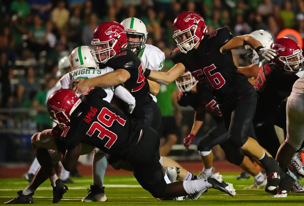 September 15, 2022; Phoenix, Arizona; USA; A group of Brophy defenders tackle St. Mary’s Julian Pompa (6) at Central High School.