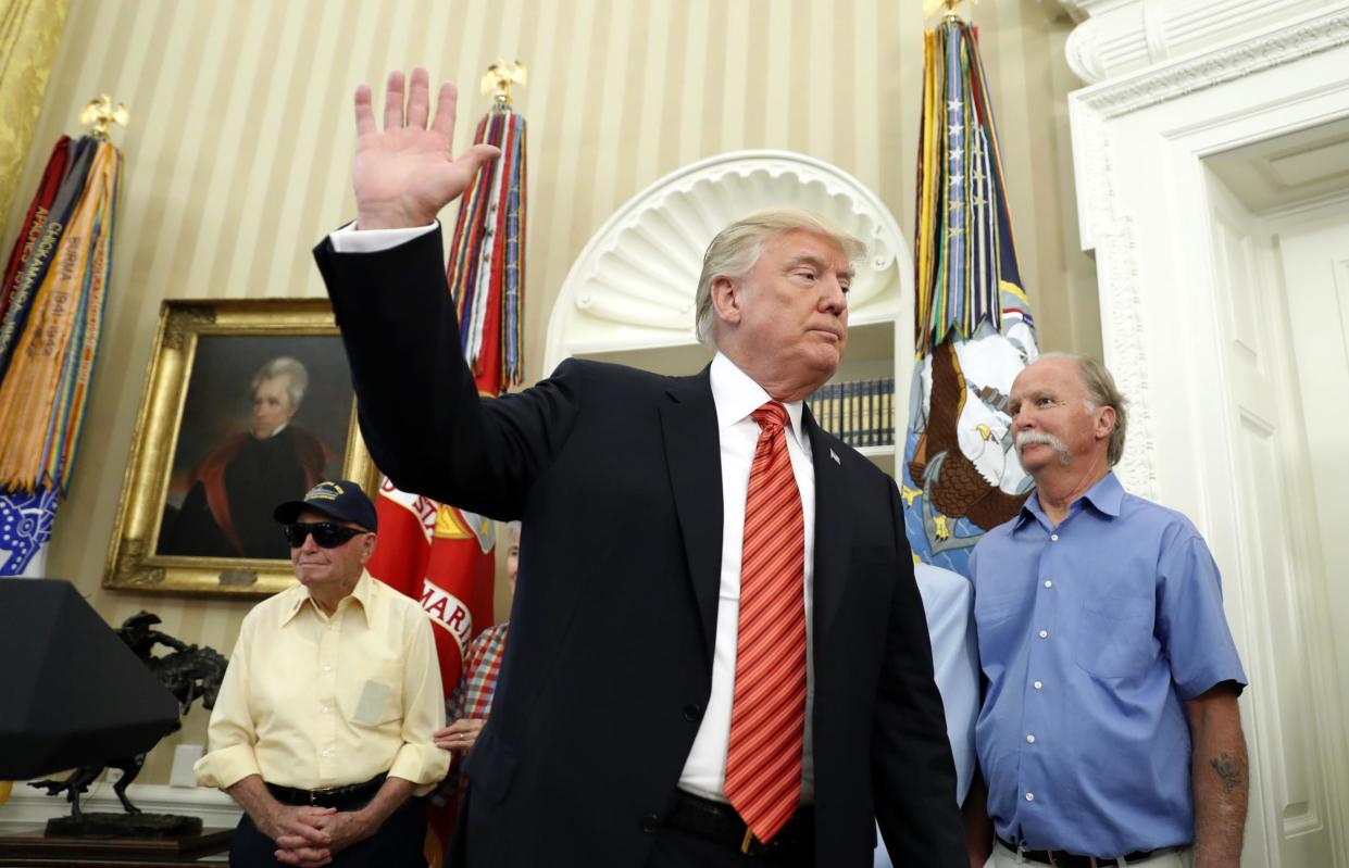 President Donald Trump waves as he departs after a meeting with survivors of the attack on USS Arizona at Pearl Harbor: AP