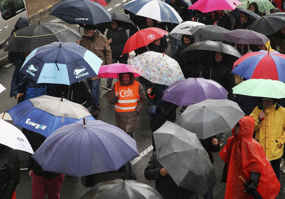 Demonstrators from the CFDT union walk during a demonstration, Thursday, Jan. 19, 2023 in Bayonne, southwestern France. French workers angry over proposed changes to retirement rules are halting high-speed trains, disrupting electricity supplies and taking to the streets Thursday in a day of nationwide strikes and protests seen as a major test for Emmanuel Macron and his presidency.(AP Photo/Bob Edme)