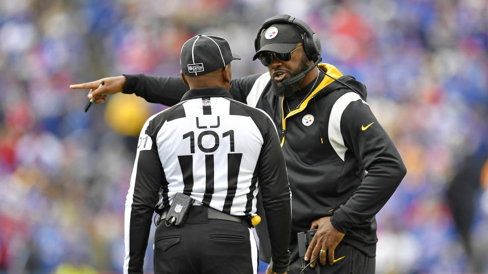 Pittsburgh Steelers head coach Mike Tomlin talks with Line Judge Carl Johnson (101) during the second half of an NFL football game against the Buffalo Bills in Orchard Park, N.Y., Sunday, Oct. 9, 2022. The Bills won 38-3. (AP Photo/Adrian Kraus)