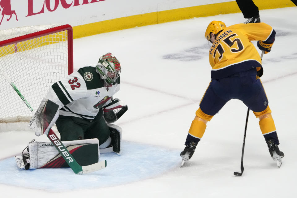 Nashville Predators center Juuso Parssinen (75) scores the winning goal against Minnesota Wild goaltender Filip Gustavsson (32) with a shot from between his legs during overtime of an NHL hockey game Thursday, April 13, 2023, in Nashville, Tenn. (AP Photo/Mark Humphrey)