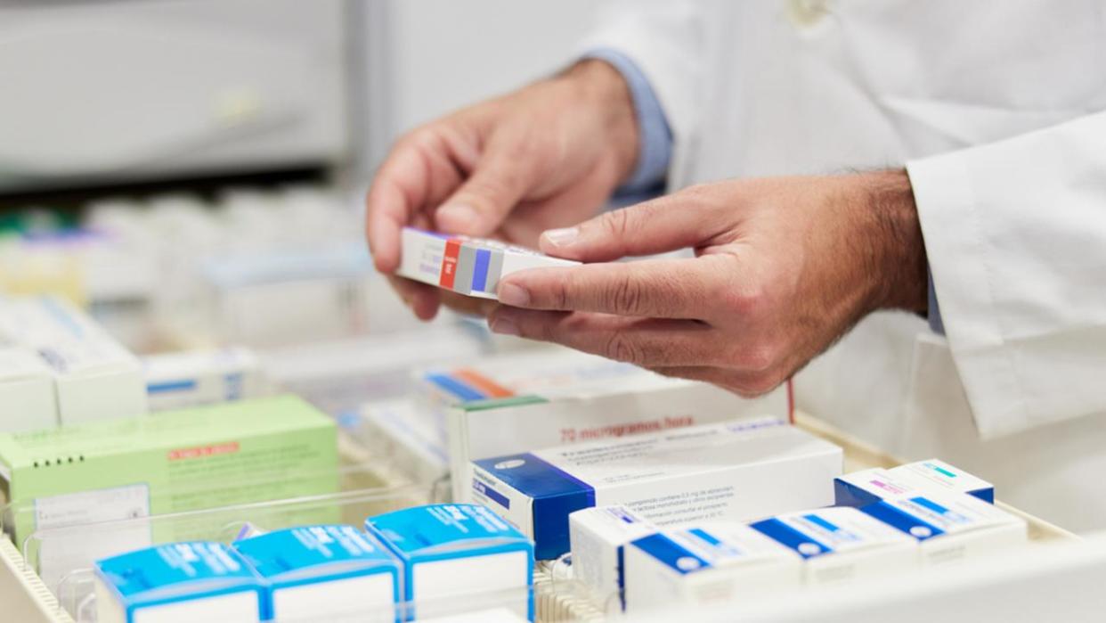 Cloe-up view of a pharmacist hands holding merchandise.