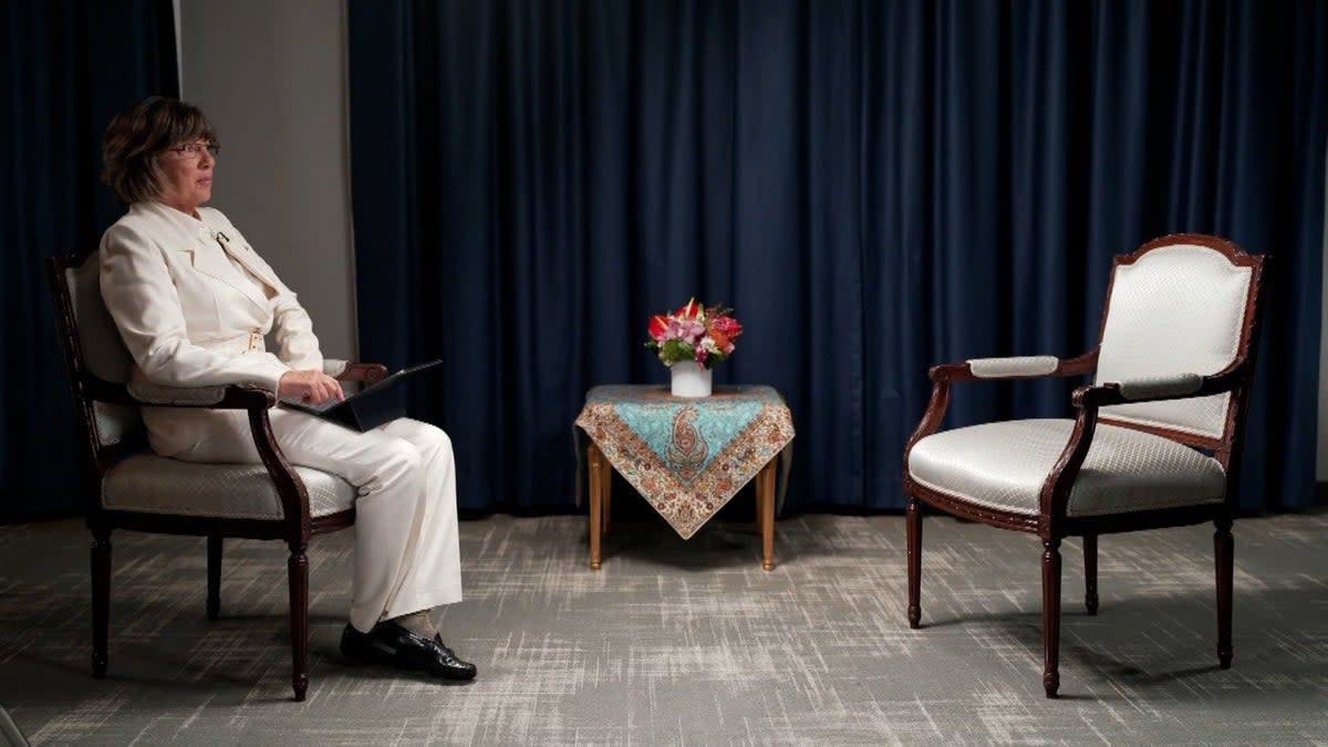 Christiane Amanpour sits next to an empty chair after Iran’s president Ebrahim Raisi backed out of an interview over her refusal to wear a headscarf  (Christiane Amanpour Twitter)