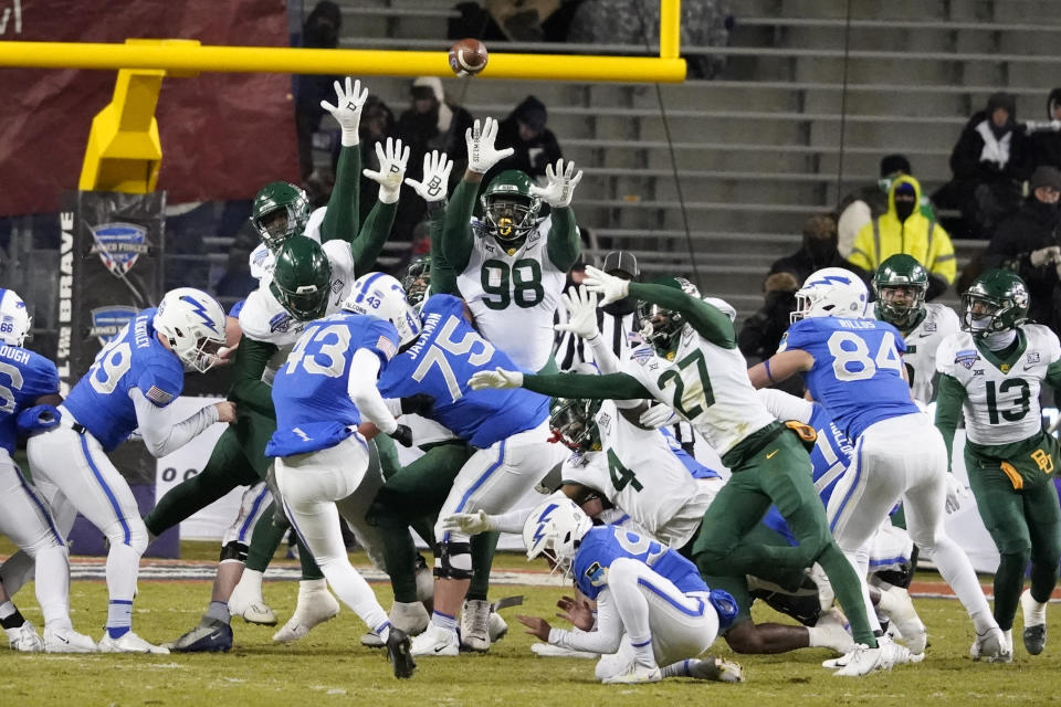 Air Force place kicker Matthew Dapore (43) has his field-goal attempt blocked as Baylor defensive lineman Chidi Ogbonnaya (98) and others defend during the first half of the Armed Forces Bowl NCAA college football game in Fort Worth, Texas, Thursday, Dec. 22, 2022. (AP Photo/LM Otero)