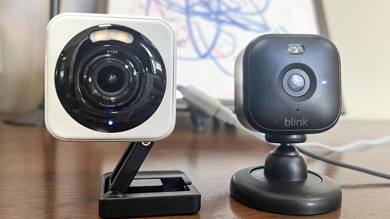  Wyze Cam 4 on table side by side with the Blink Mini 2 security camera. 