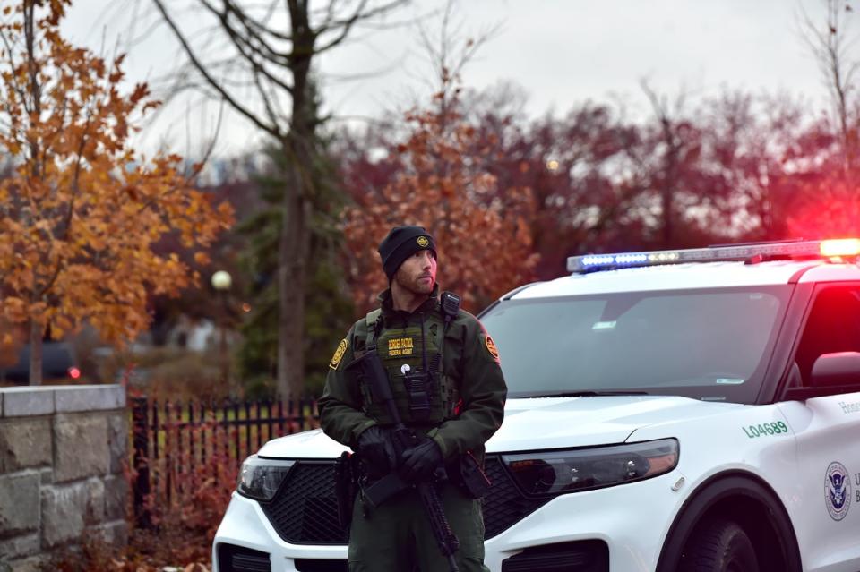 A member of the Border Patrol stands guard as Homeland Security, Border Patrol, and local authorities block traffic to the Rainbow Bridge (Getty Images)