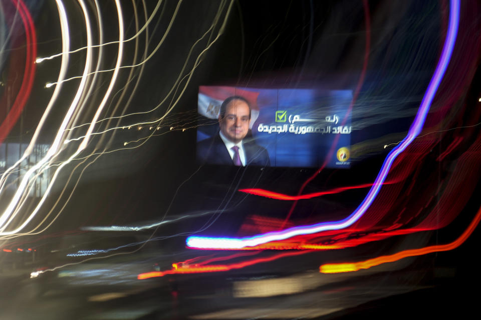 In this photo made with a slow shutter speed, vehicles pass under a billboard supporting Egyptian President Abdel Fattah el-Sissi for the coming presidential elections, in Cairo, Egypt, Monday, Sept. 25, 2023. Arabic reads "Yes to the leader of the New Republic". Egypt will hold a presidential election over three days in December, officials announced Monday, with President Abdel Fattah el-Sissi highly likely to prolong his stay in power until 2030. (AP Photo/Amr Nabil)