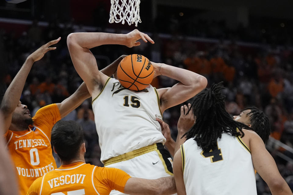 Purdue center Zach Edey (15) grabs a rebound during the second half of an Elite Eight college basketball game against Tennessee in the NCAA Tournament, Sunday, March 31, 2024, in Detroit. (AP Photo/Paul Sancya)