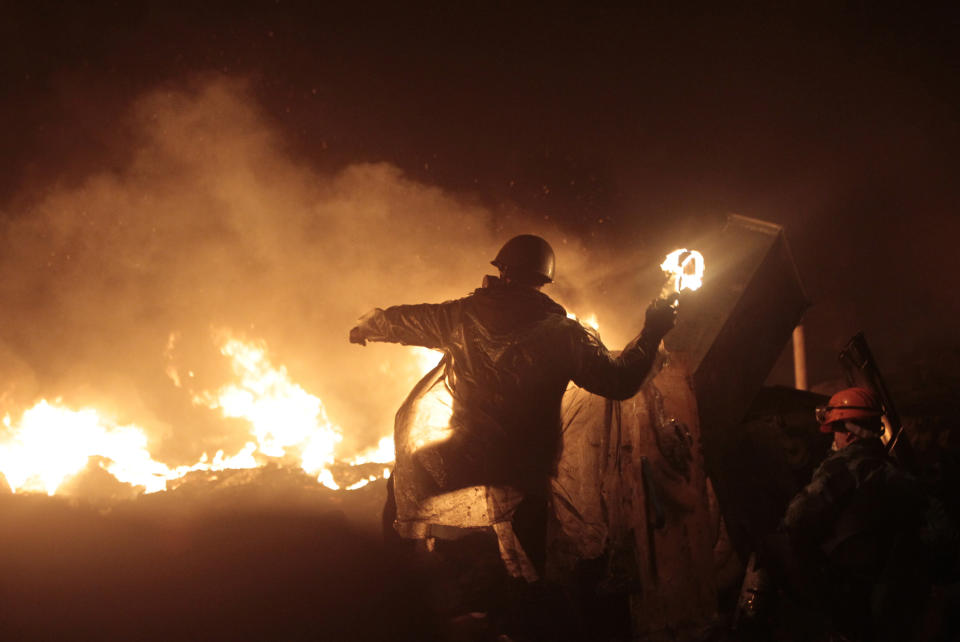 Anti-government protesters clash with riot police in Kiev's Independence Square, the epicenter of the country's current unrest, in Ukraine, Thursday, Feb. 20, 2014. Ukraine's protest leaders and the president they aim to oust called a truce Wednesday, just hours after the military raised fears of a widespread crackdown with a vow to defeat "terrorists" responsible for seizing weapons and burning down buildings. (AP Photo/Sergei Chuzavkov)