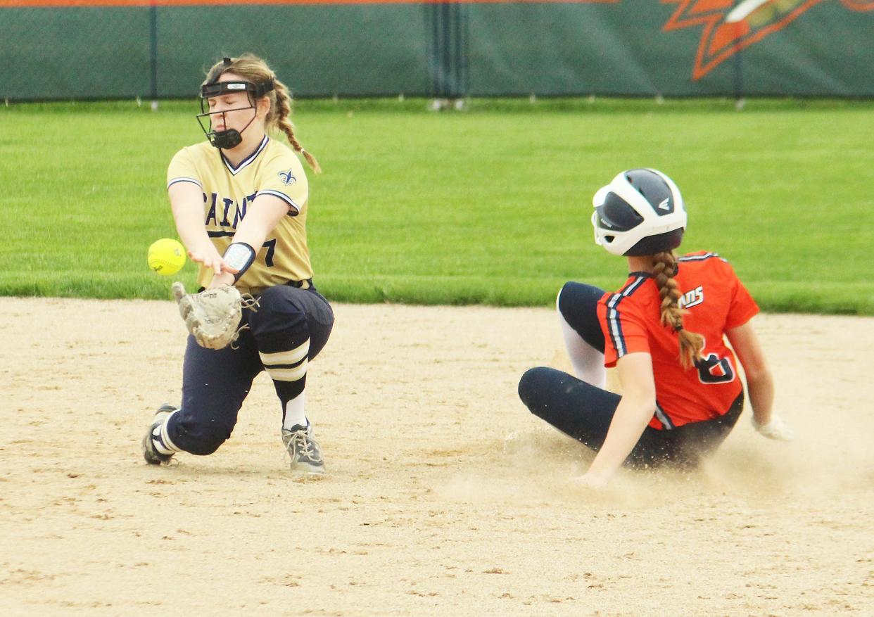 Pontiac's Elena Krause slides safely into second base with a stolen base as the Central Catholic shortstop has trouble controlling the ball. Krause and the Indians rolled BCC 16-1 in an Illini Prairie Conference softball contest Monday.