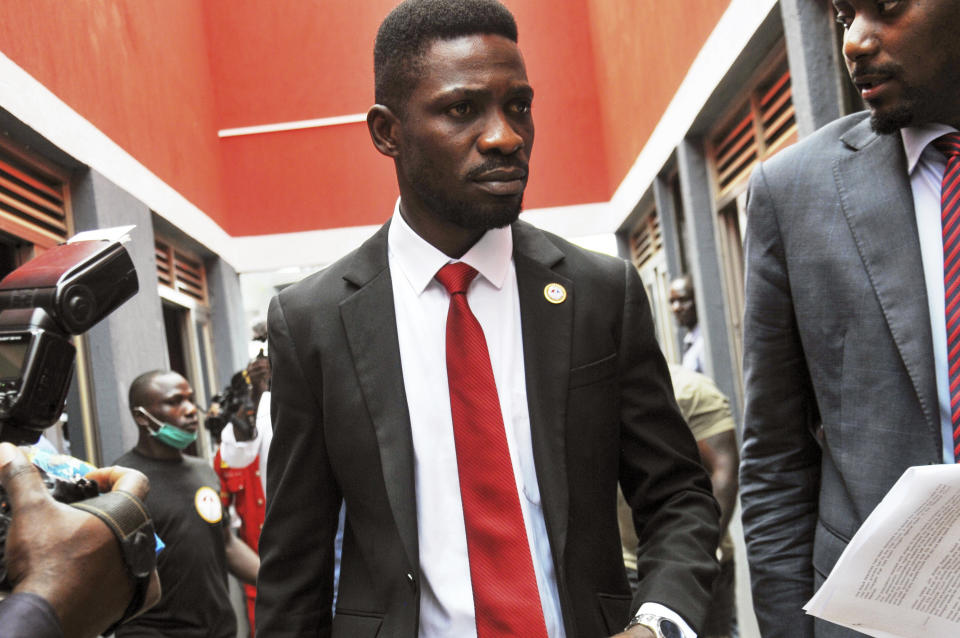 Bobi Wine, center, a singer and lawmaker whose real name is Kyagulanyi Ssentamu, arrives to speak at the National Unity Platform (NUP) head office in the Kamwokya suburb of Kampala, Uganda Monday, Aug. 31, 2020. Bobi Wine, who spoke on Monday to answer questions swirling around his age and academic record, cited "a pattern of repression and suppression" aiming to derail his bid against the long-time president Yoweri Museveni in polls scheduled for 2021. (AP Photo/Ronald Kabuubi)