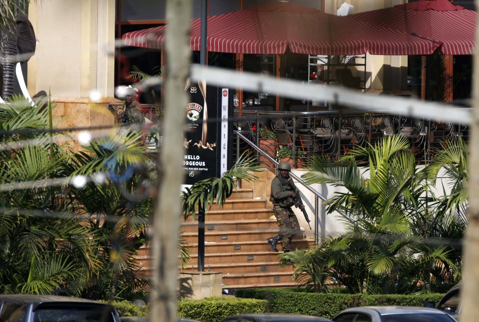 A Kenyan soldier walks out of the main gate of Westgate Shopping Centre in Nairobi