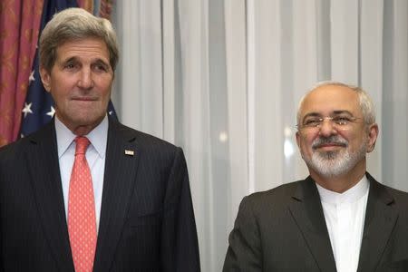 U.S. Secretary of State John Kerry (L) and Iran's Foreign Minister Mohammad Javad Zarif pose for a photograph before resuming talks over Iran's nuclear programme in Lausanne March 16, 2015. REUTERS/Brian Snyder