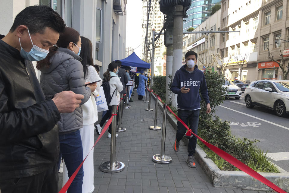 Residents line up for COVID tests on a street in Shanghai, China, Tuesday, March 29, 2022. A two-phase lockdown of Shanghai's 26 million people is testing the limits of China's hard-line "zero-COVID" strategy, which is shaking markets far beyond the country's borders. (AP Photo/Chen Si)