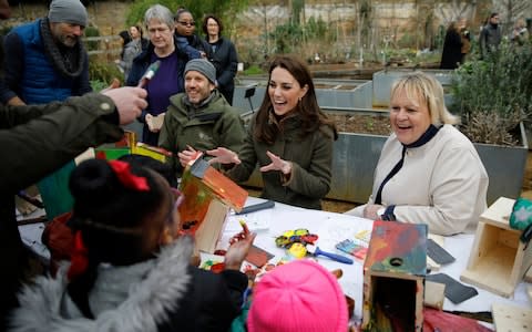 The Duchess of Cambridge helps make bird boxes as she visits the Islington community garden in north London - Credit: AFP pool