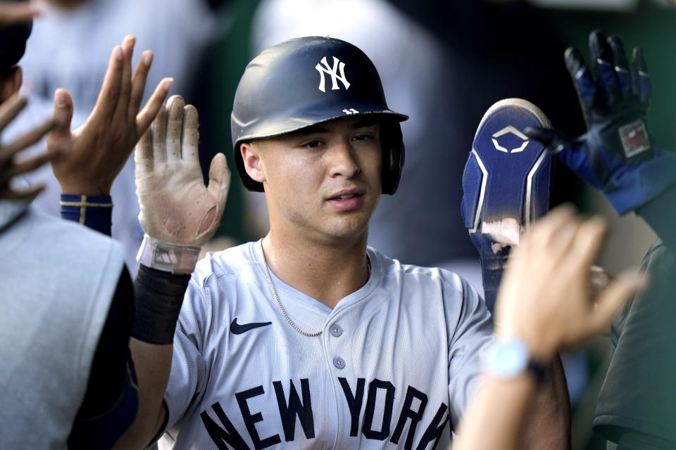 New York Yankees' Anthony Volpe celebrates in the dugout after scoring on a two-run single by Alex Verdugo during the first inning of a baseball game against the Kansas City Royals Wednesday, June 12, 2024, in Kansas City, Mo. (AP Photo/Charlie Riedel)