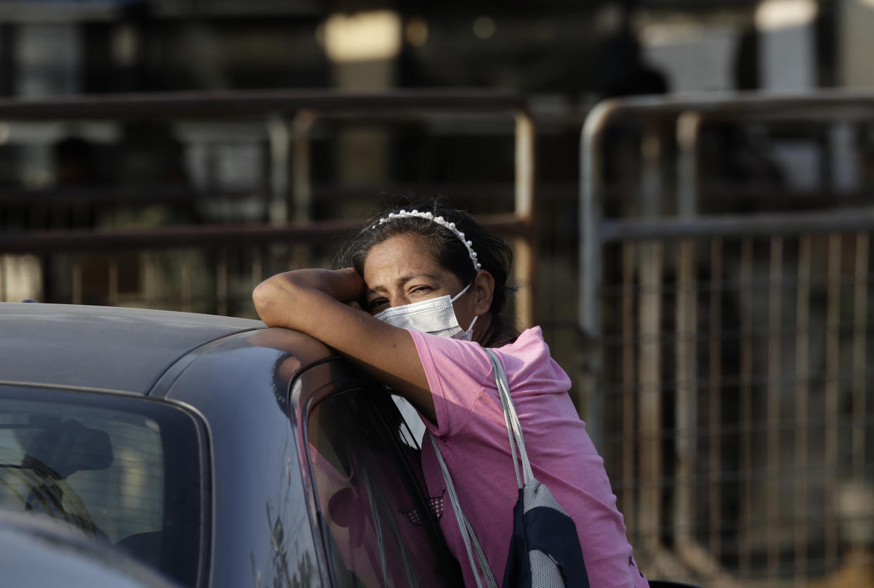 A relative of an inmate awaits news outside the Litoral Penitentiary in Guayaquil, Ecuador, Wednesday, September 29, 2021. The authorities have reported at least 100 dead and 52 injured in a riot on Tuesday at the prison. (AP Photo/Angel DeJesus)