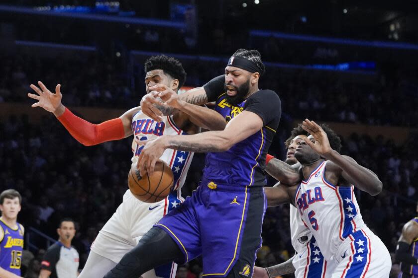 Los Angeles Lakers forward Anthony Davis, center, and Philadelphia 76ers forward Tobias Harris.