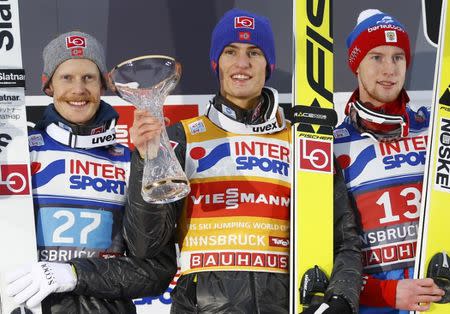 Ski Jumping - 65th four-hills ski jumping tournament first round - Innsbruck - 04/01/2017 - Norway's Daniel Andre Tande, his compatriot Robert Johanssone and Russia's Evgeniy Klimov react on the winners podium. REUTERS/Dominic Ebenbichler