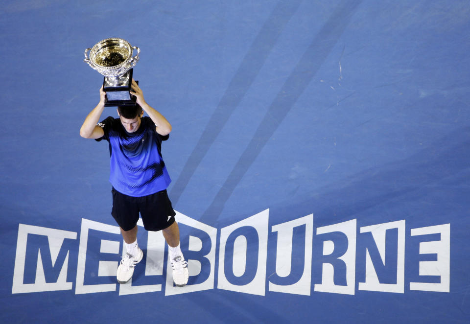 FILE - Serbia's Novak Djokovic holds a trophy after beating Jo-Wilfried Tsonga, of France, in the final of the Men's singles at the Australian Open tennis tournament in Melbourne, Australia, Sunday, Jan. 27, 2008. Djokovic will be trying to set the record for the most Grand Slam singles trophies won by a man when he goes for what would be No. 23 against Casper Ruud in the French Open final on Sunday, June 11, 2023. Djokovic enters that match with 22, tied with his rival Rafael Nadal. Roger Federer, who announced his retirement last year, is next with 20. (AP Photo/Mark Baker, File)