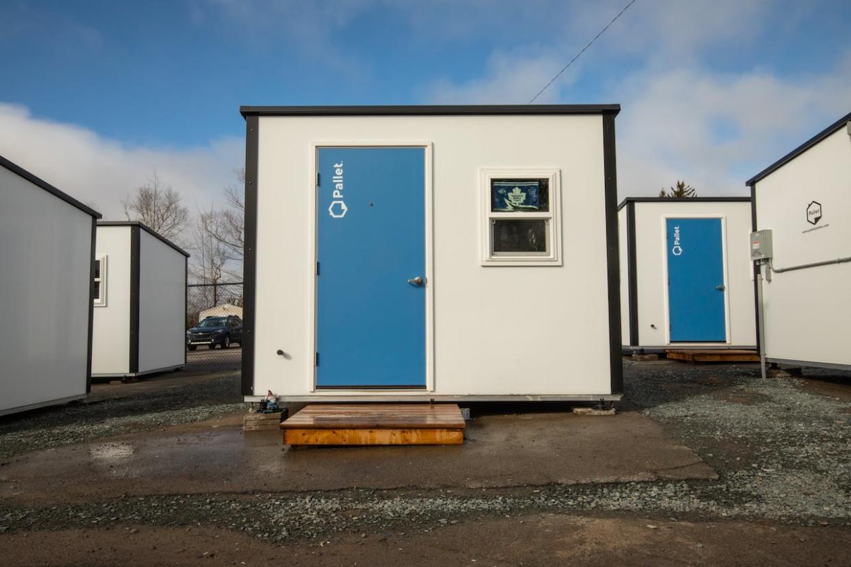 The province bought 200 Pallet shelters last fall and is still searching for appropriate locations and service providers for many of them. (Kelly Clark/The Canadian Press - image credit)