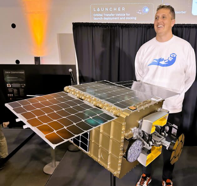 Starfish Space co-founder Austin Link shows off a replica of the Otter Pup spacecraft at Seattle’s Museum of Flight. Link says Starfish’s workforce has risen to 24 employees “and growing.” (GeekWire Photo / Alan Boyle)