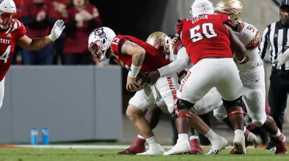 Florida State defensive tackle Malcolm Ray (99) sacks N.C. State quarterback Devin Leary (13) during the first half of N.C. State’s game against Florida State at Carter-Finley Stadium in Raleigh, N.C., Saturday, Oct. 8, 2022.