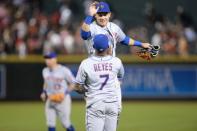 Jun 16, 2018; Phoenix, AZ, USA; New York Mets left fielder Michael Conforto (30) and shortstop Jose Reyes (7) slap hands after defeating the Arizona Diamondbacks at Chase Field. Mandatory Credit: Joe Camporeale-USA TODAY Sports