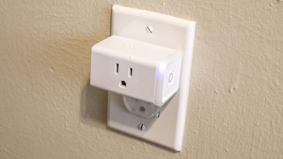 A TP-Link Kasa Smart Plug plugged into a wall outlet