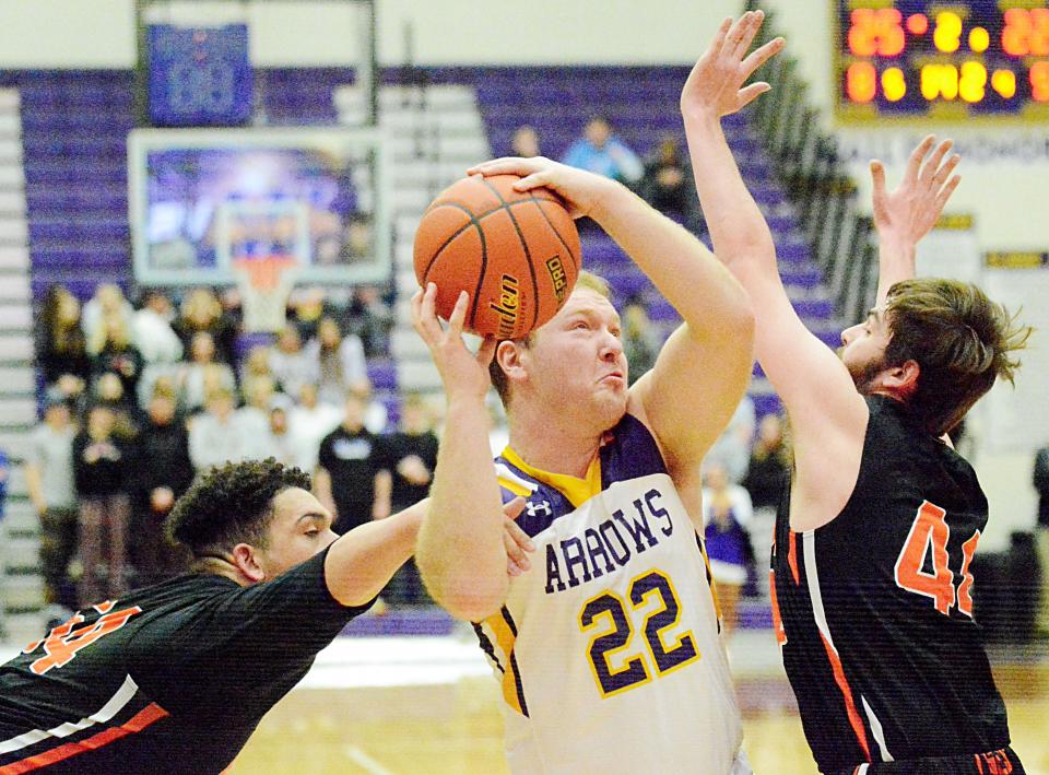 Watertown's Mack Johnson (22) attempts to shoot against Huron's Isaiah Decker (left) and Brandon Decker during their Eastern South Dakota Conference boys basketball game Tuesday night in the Civic Arena. Watertown won 59-44.