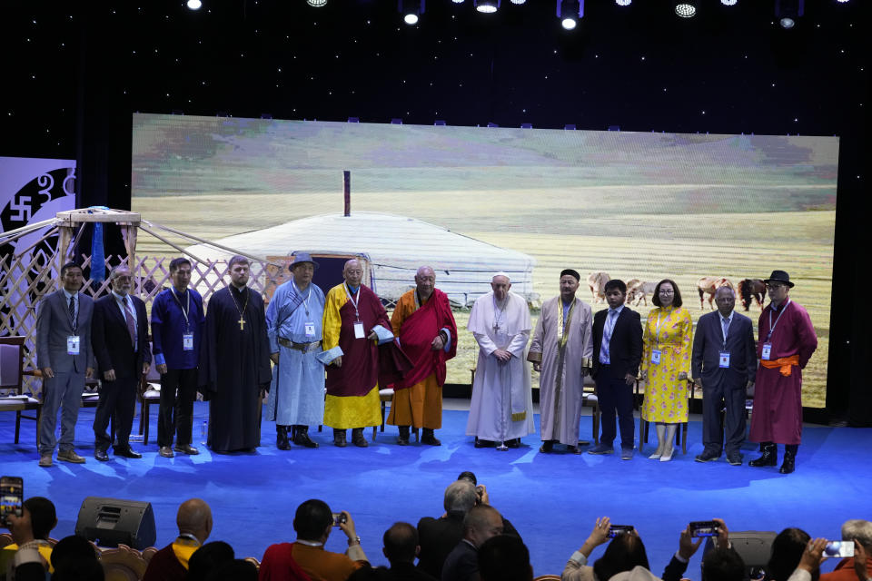 Religious leaders with Pope Francis, 8th from left, pose for a family photo at the end of a meeting at the Hun Theatre in the Sky Resort compound some 15 kilometers south of the Mongolian capital Ulaanbaatar, Sunday, Sept. 3, 2023. Pope Francis has praised Mongolia's tradition of religious freedom dating to the times of founder Genghis Khan during the first-ever papal visit to the Asian nation. (AP Photo/Andrew Medichini)