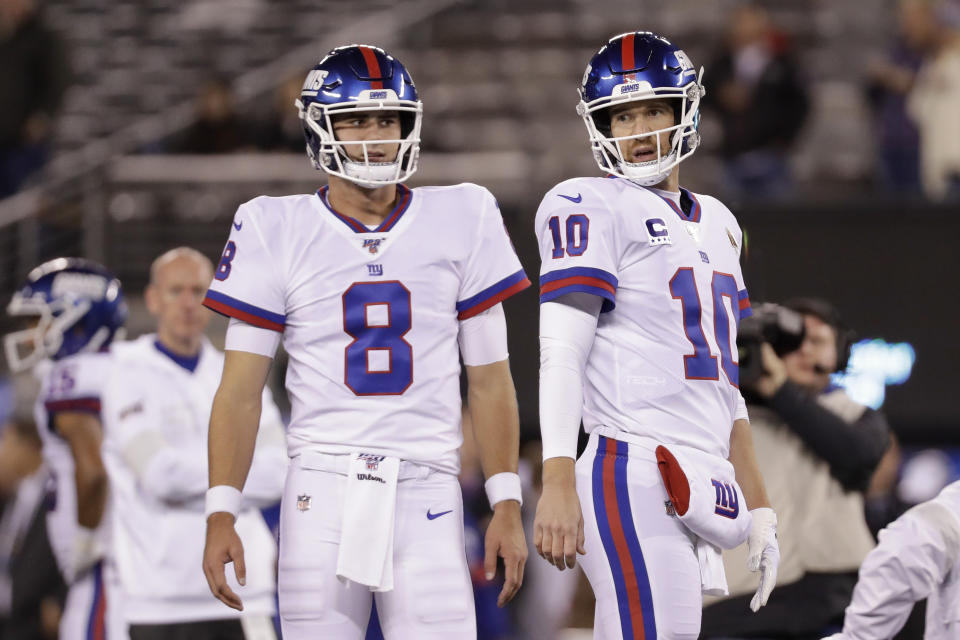 FILE - In this Nov. 4, 2019, file photo, New York Giants quarterback Daniel Jones (8) and quarterback Eli Manning (10) warm up before an NFL football game against the Dallas Cowboys, in East Rutherford, N.J. Giants quarterback Daniel Jones was kept out of practice Wednesday, Dec. 4, 2019, with a high right ankle sprain, and coach Pat Shurmur says Eli Manning “very likely” will start Monday night against the Philadelphia Eagles. Shurmur adds that Manning could very well be the starter for the rest of the season. (AP Photo/Adam Hunger, File)