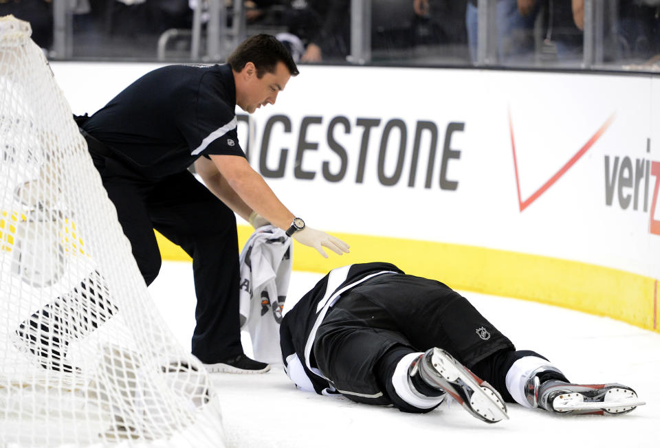 LOS ANGELES, CA - JUNE 11: Rob Scuderi #7 of the Los Angeles Kings lays on the ice after being boarded by Steve Bernier #18 of the New Jersey Devils (not in photo) in Game Six of the 2012 Stanley Cup Final at Staples Center on June 11, 2012 in Los Angeles, California. (Photo by Harry How/Getty Images)