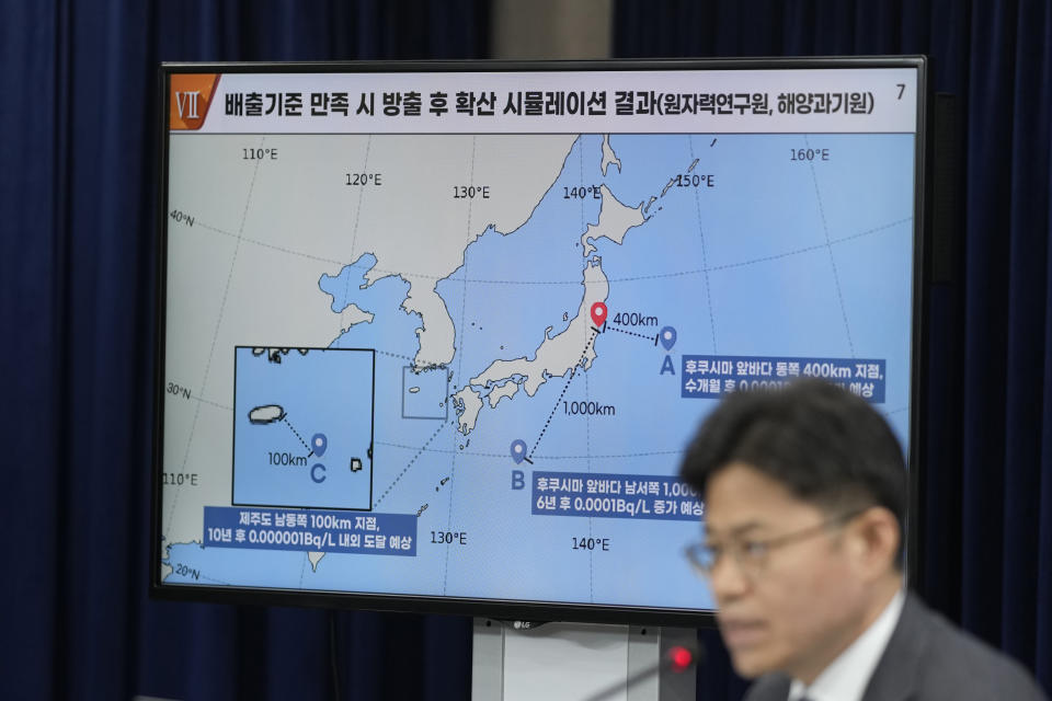 A screen shows the simulation analysis as Yoo Guk-hee, chairperson of Nuclear Safety and Security Commission, speaks during a briefing at the government complex in Seoul, South Korea, Friday, July 7, 2023. South Korean government held the briefing to explain the result of its review of Japan's treated radioactive water discharge plan and said the plan meets international standard if carried out as planned. (AP Photo/Lee Jin-man)
