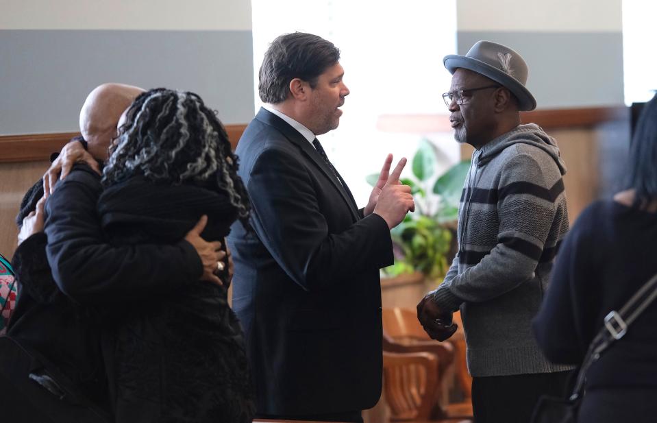 Glynn Simmons, right, speaks with attorney Joe Norwood on Tuesday after Judge Amy Palumbo's ruling.