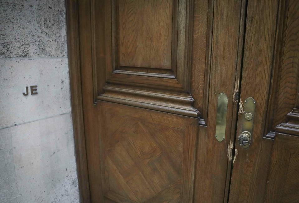 This photo shows the initials "JE" and doorway damage at the Manhattan residence of Jeffrey Epstein, Monday July 8, 2019, in New York. Prosecutors said Monday, federal agents investigating wealthy sex offender Jeffrey Epstein found "nude photographs of what appeared to be underage girls" while searching his Manhattan mansion. (AP Photo/Bebeto Matthews)