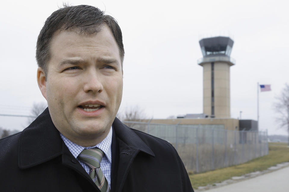 In this March 11, 2013 photo, Mark Hanna, director of the Abraham Lincoln Capital Airport in Springfield, Ill., talks about the possible closing of the air traffic control tower behind him and nearly 240 more around the country under federal budget cuts. Airport directors and pilots are concerned that eliminating a second pair of eyes on the ground will increase risk throughout the American air-transport system, the world’s safest. (AP Photo/Seth Perlman)