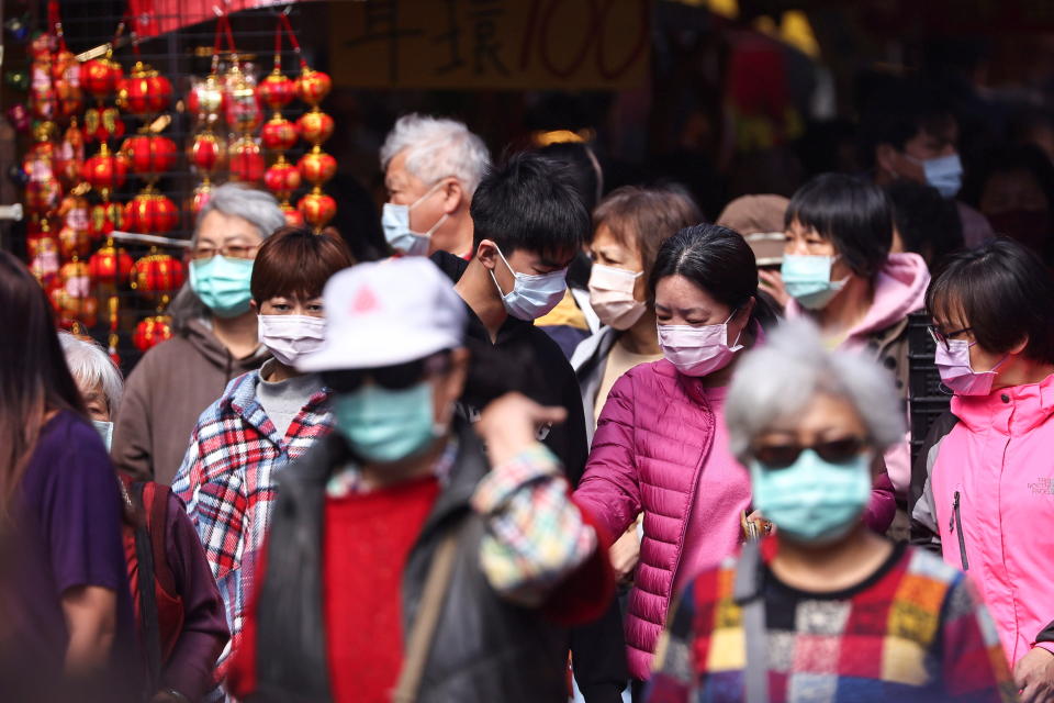 People shop while wearing a protective mask to prevent the spread of coronavirus disease (COVID-19) ahead of the Lunar New Year holiday in Taipei, Taiwan, February 10, 2021. REUTERS/Ann Wang
