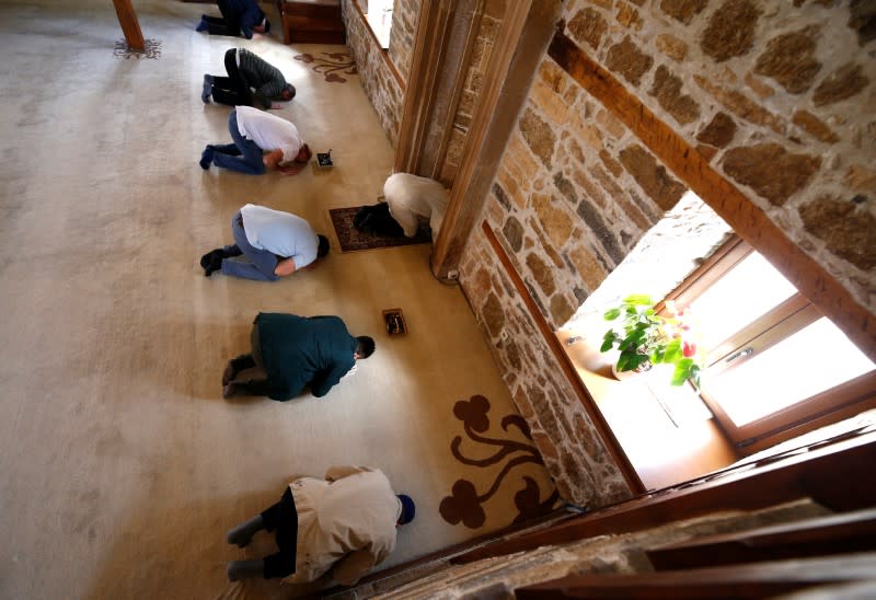 Members of local Islamic council (Dzemat) pray in an almost empty Sultan Ahmed mosque, as Friday prayers were suspended following the spread of the coronavirus disease (COVID-19), in Zenica