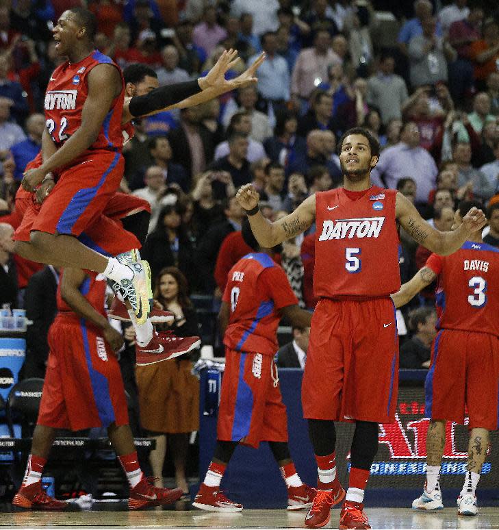Dayton forward Kendall Pollard (22) celebrates after the second half in a regional semifinal game against Stanford at the NCAA college basketball tournament, Thursday, March 27, 2014, in Memphis, Tenn. Dayton won 82-72. (AP Photo/John Bazemore)