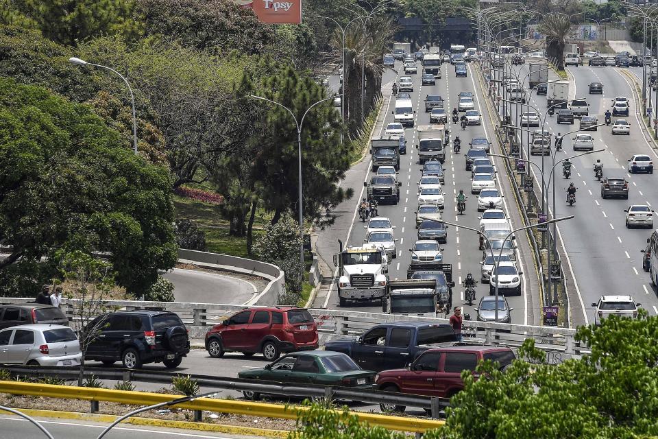 Cars are at a standstill along the Gran Cacique Guaicaipuro highway of Caracas, Venezuela, Wednesday, April 20, 2022. Venezuela's roads are full of high-mileage, money-sucking vehicles, many that predate the socialist transformation ushered in by the late President Hugo Chavez at the turn of the century. (AP Photo/Matias Delacroix)