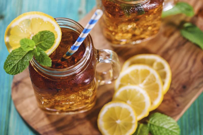 Freshly made ice tea with lemon and mint in a jar