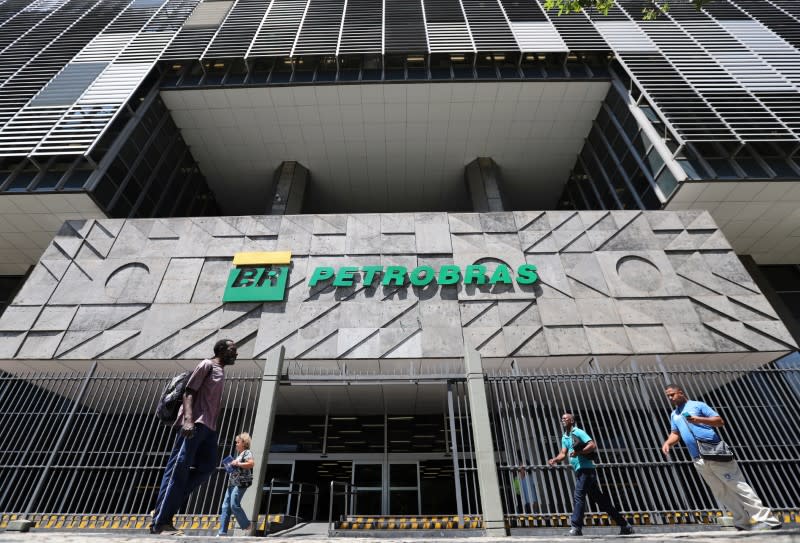 People walk in front of the headquarters of Petroleo Brasileiro S.A. (Petrobas) in Rio de Janeiro