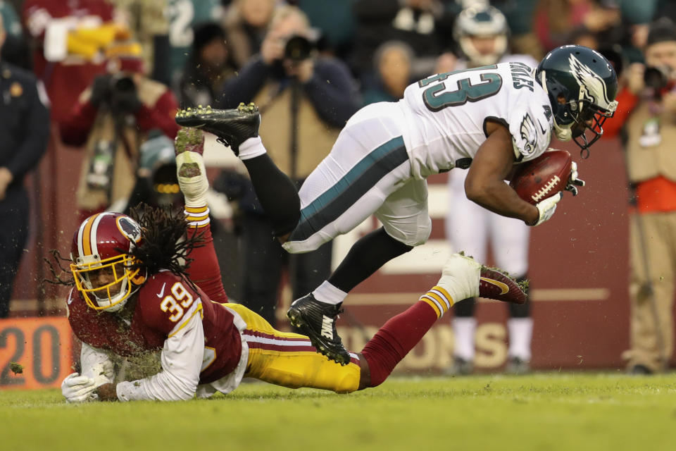 Philadelphia Eagles running back Darren Sproles (43) is kicked off his feet by Washington Redskins defensive back Adonis Alexander (39) during the first half of the NFL football game, Sunday, Dec. 30, 2018 in Landover, Md. (AP Photo/Andrew Harnik)