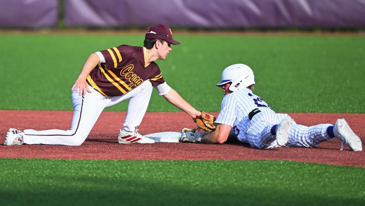 Bloomington North’s Chris Barnett (1) tags Bloomington South’s Jake Arnett trying to steal second base during the baseball game at South on Thursday, April 25, 2024.