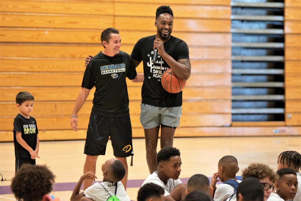 Jamaal Franklin, right, hugs Serrano boys basketball head coach Jonathan Beck during the Jamaal Franklin’s Skill Academy on Saturday, Aug. 5, 2023, at Serrano High School. Well over 100 kids from the ages of 6 to 16 attended Franklin's camp at his alma mater.