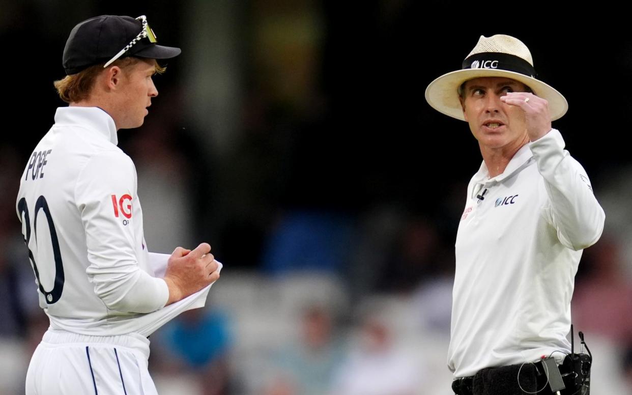 Ollie Pope chats to the umpire Chris Gaffaney